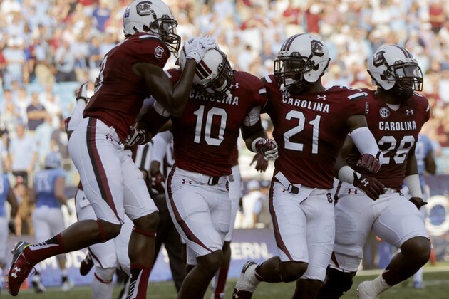 South Carolina's Skai Moore (10) celebrates with teammates after his interception against North Carolina in the first half of an NCAA college football game in Charlotte, N.C., Thursday, Sept. 3, 2015. (AP Photo/Chuck Burton)