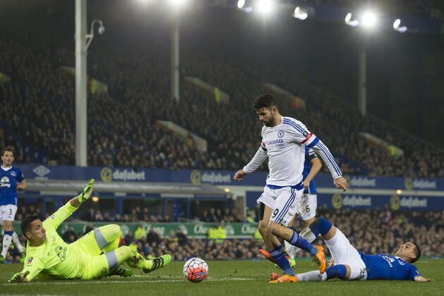 Chelsea's Diego Costa, centre, narrowly fails to score past Everton's goalkeeper Joel Robles, left, and Ramiro Funes Mori during the English FA Cup quarter-final soccer match between Everton and Chelsea at Goodison Park Stadium, Liverpool, England, Saturday March 12, 2016. (AP Photo/Jon Super)
