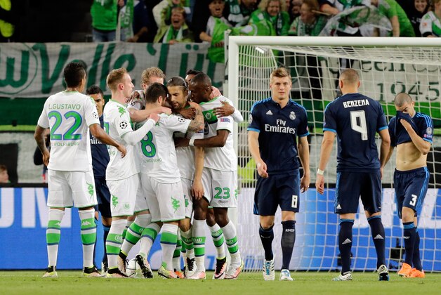 Wolfsburg's players celebrate after Ricardo Rodriguez scored the opening goal from the penalty spot during the Champions League first leg quarter final soccer match between VfL Wolfsburg and Real Madrid in Wolfsburg, Germany, Wednesday, April 6, 2016. (AP Photo/Markus Schreiber)