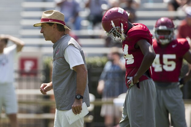 Alabama coach Nick Saban, front left, runs drills during an NCAA college football practice, Sunday, Aug. 9, 2015, in Tuscaloosa, Ala. (AP Photo/Brynn Anderson)