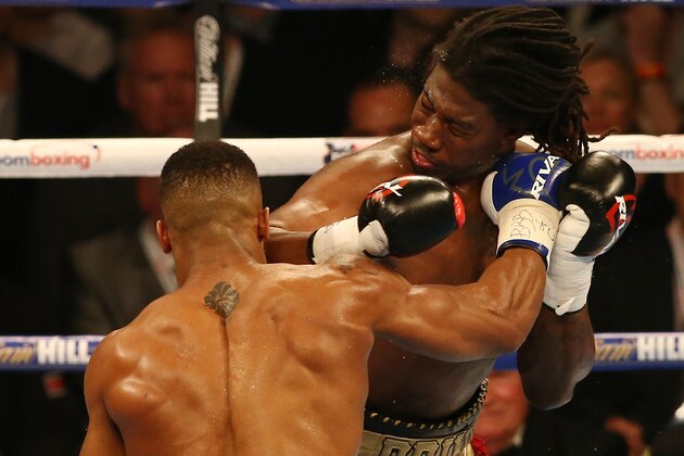British boxer Anthony Joshua (L) and US boxer Charles Martin (R) vie during their IBF World Heavyweight title boxing match at the O2 arena in London on April 9, 2016.Britain's Anthony Joshua won the IBF world heavyweight title with a sensational second round knockout of outclassed American rival Charles Martin. Olympic champion Joshua, 26, had Martin on the canvas twice in the second round to record his 16th knockout in all 16 professional fights he has contested. Joshua becomes the sixth British fighter to win a world heavyweight title.  / AFP / JUSTIN TALLIS        (Photo credit should read JUSTIN TALLIS/AFP/Getty Images)