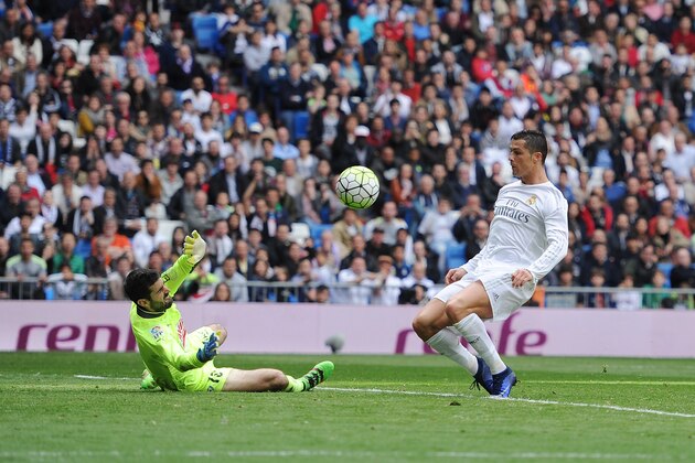 MADRID, SPAIN - APRIL 09:  Cristiano Ronaldo of Real Madrid shoots past Asier Riesgo to score his sid's 2rd goal during the La Liga match between Real Madrid and Eibar at Estadio Santiago Bernabeu on April 9, 2016 in Madrid, Spain.  (Photo by Denis Doyle/Getty Images)