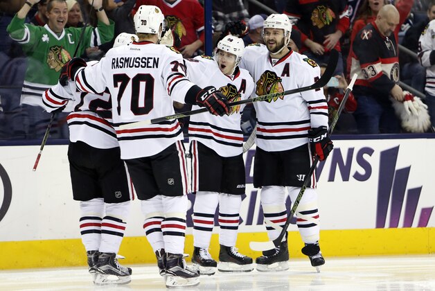 Chicago Blackhawks' Patrick Kane, center, and Brent Seabrook, right, celebrate Kane's goal against the Columbus Blue Jackets with teammates during the first period of an NHL hockey game Saturday, April 9, 2016, in Columbus, Ohio. (AP Photo/Jay LaPrete)