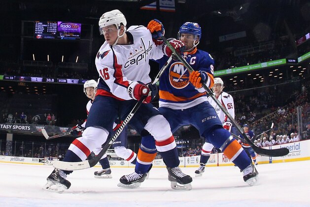 NEW YORK, NY - JANUARY 07: John Tavares #91 of the New York Islanders skates against Michael Latta #46 of the Washington Capitals at the Barclays Center on January 7, 2016 in the Brooklyn borough of New York City. The Capitals defeated the Islanders 4-1.  (Photo by Bruce Bennett/Getty Images)