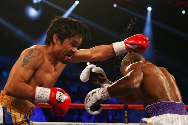 LAS VEGAS, NEVADA - APRIL 09:  Manny Pacquiao (L) throws a left against Timothy Bradley Jr. during their welterweight championship fight on April 9, 2016 at MGM Grand Garden Arena in Las Vegas, Nevada.  (Photo by Christian Petersen/Getty Images)