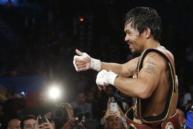 Manny Pacquiao, of the Philippines, celebrates after defeating Timothy Bradley in the WBO welterweight title boxing bout Saturday, April 9, 2016, in Las Vegas. (AP Photo/Isaac Brekken)