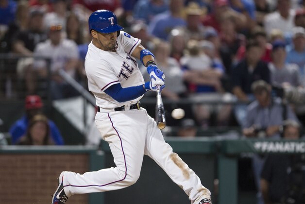 Apr 5, 2016; Arlington, TX, USA; Texas Rangers catcher Robinson Chirinos (61) hits a single and drives in a run against the Seattle Mariners during the fourth inning at Globe Life Park in Arlington. Mandatory Credit: Jerome Miron-USA TODAY Sports