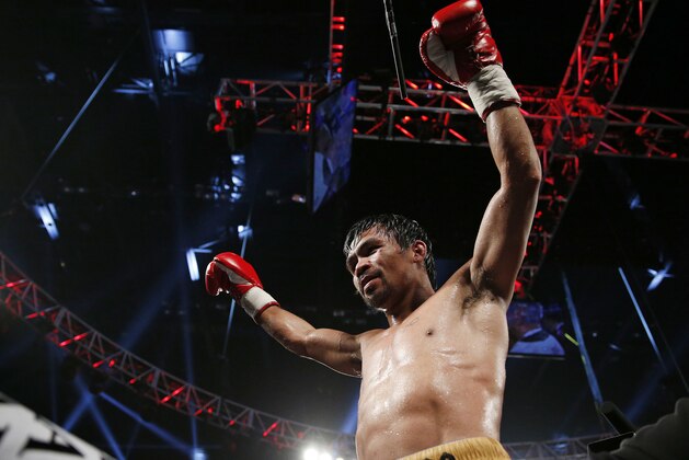 Manny Pacquiao, of the Philippines, celebrates after defeating Timothy Bradley in the WBO welterweight title boxing bout Saturday, April 9, 2016, in Las Vegas. (AP Photo/John Locher)