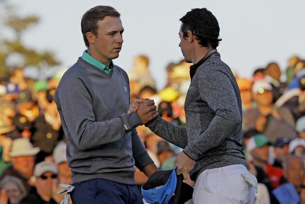 Jordan Spieth, left, shakes hands with Rory McIlroy, of Northern Ireland, on the 18th green during the third round of the Masters golf tournament Saturday, April 9, 2016, in Augusta, Ga. (AP Photo/David J. Phillip)