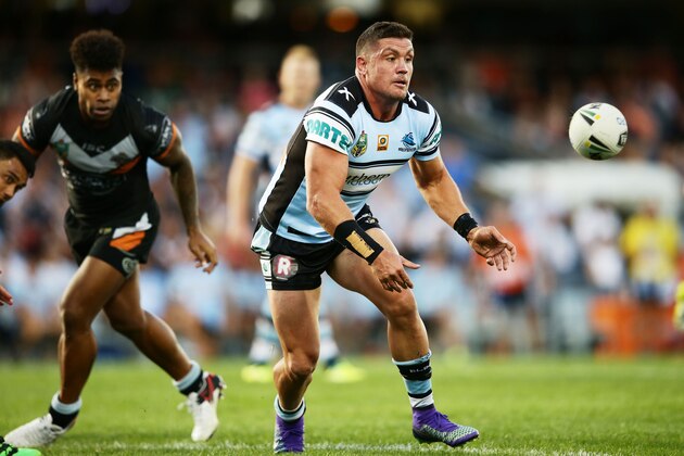 SYDNEY, NEW SOUTH WALES - APRIL 02:  Chris Heighington of the Sharks passes during the round five NRL match between the Wests Tigers and the Cronulla Sharks at Campbelltown Sports Stadium on April 2, 2016 in Sydney, Australia.  (Photo by Matt King/Getty Images)