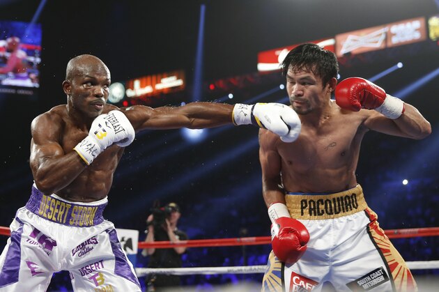 Timothy Bradley, left, hits Manny Pacquiao, of the Philippines, during their WBO welterweight title boxing bout Saturday, April 9, 2016, in Las Vegas. (AP Photo/Isaac Brekken)