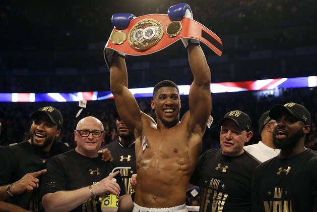 British boxer Anthony Joshua celebrates after winning the IBF heavyweight title bout between US boxer Charles Martin and British boxer Anthony Joshua at the O2 Arena in London, Saturday, April 9, 2016.(AP Photo/Matt Dunham)