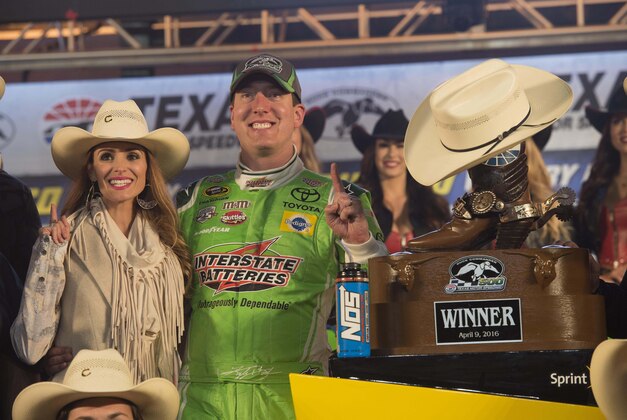 Apr 9, 2016; Fort Worth, TX, USA; Sprint Cup Series driver Kyle Busch (18) and Samantha Busch (L) celebrate in victory lane after winning the Duck Commander 500 at Texas Motor Speedway. Mandatory Credit: Jerome Miron-USA TODAY Sports