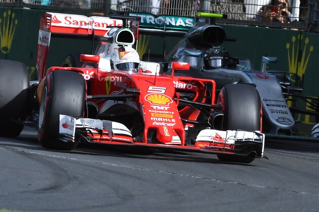 Ferrari's German driver Sebastian Vettel (L) powers through a corner ahead of Mercedes AMG Petronas F1 Team's German driver Nico Rosberg (R) during the Formula One Australian Grand Prix in Melbourne on March 20, 2016.  / AFP / Paul Crock / IMAGE RESTRICTED TO EDITORIAL USE - STRICTLY NO COMMERCIAL USE        (Photo credit should read PAUL CROCK/AFP/Getty Images)