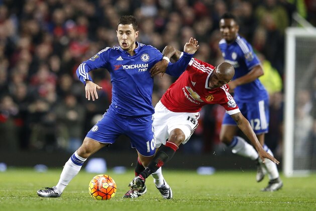 Chelsea's Eden Hazard, left, is challenged by Manchester United's Ashley Young during the English Premier League soccer match between Manchester United and Chelsea at Old Trafford Stadium, Manchester, England, Monday, Dec. 28, 2015. (AP Photo/Jon Super)