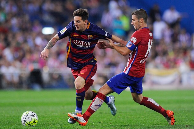 MADRID, SPAIN - SEPTEMBER 12:  Gabi Fernandez of Club Atletico de Madrid tries to stop Lionel Messi of FC Barcelona during the La Liga match between Club Atletico de Madrid and FC Barcelona at Vicente Calderon Stadium on September 12, 2015 in Madrid, Spain.  (Photo by Denis Doyle/Getty Images)