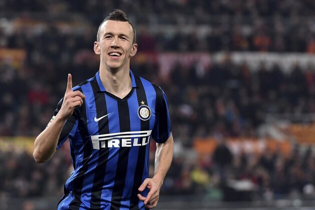Inter Milan’s Ivan Perisic celebrates after scoring during a Serie A soccer match between Roma and Inter Milan, at Rome's Olympic Stadium, Saturday, March 19, 2016. (Ettore Ferrari/ANSA via AP) ITALY OUT