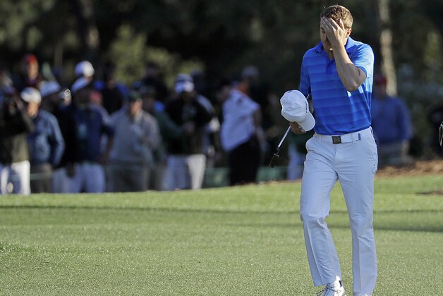Jordan Spieth walks on the 18th fairway with his caddie Michael Greller during the final round of the Masters golf tournament Sunday, April 10, 2016, in Augusta, Ga. (AP Photo/David J. Phillip)