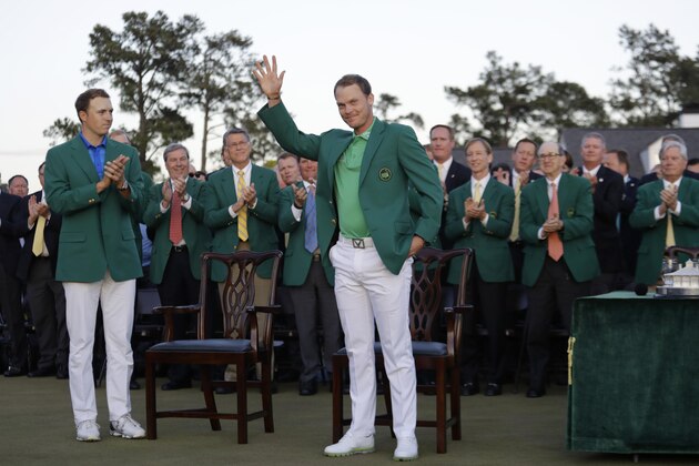Defending champion Jordan Spieth, left, applauds as Masters champion Danny Willett, of England, waves after winning the Masters golf tournament Sunday, April 10, 2016, in Augusta, Ga.  (AP Photo/Jae C. Hong)