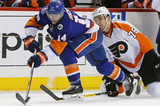 New York Islanders defenseman Thomas Hickey (14) moves the puck away from Philadelphia Flyers center Chris VandeVelde (76) during the first period of an NHL hockey game in New York, Sunday, April 10, 2016. (AP Photo/Rich Schultz)