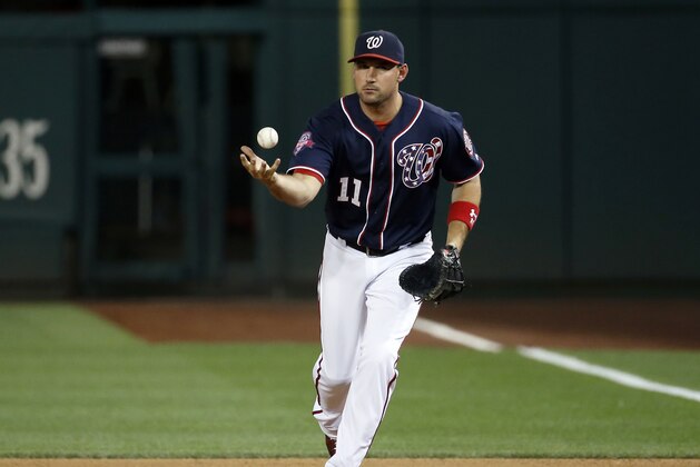 Washington Nationals first baseman Ryan Zimmerman (11) grabs a ball during a baseball game against the Milwaukee Brewers at Nationals Park, Friday, Aug. 21, 2015, in Washington. The Brewers won 10-3. (AP Photo/Alex Brandon)