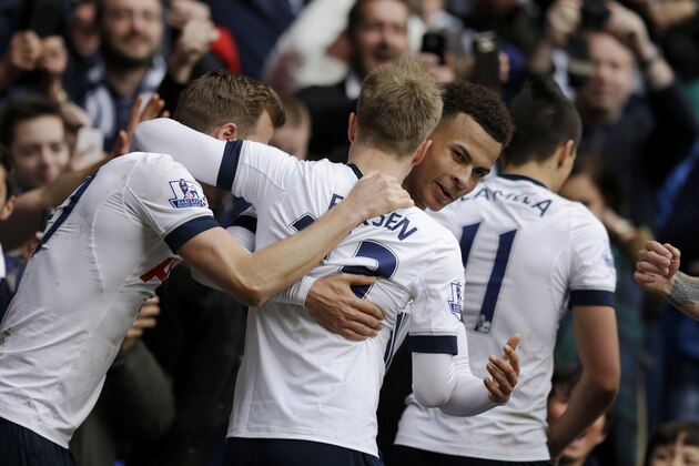 Tottenham Hotspur's Christian Eriksen, center, celebrates after making a assist for his teammate Dele Alli, second right, to score their first goal from, alongside Harry Kane, left, and Erik Lamela, right, during the English Premier League soccer match between Tottenham Hotspur and Manchester United at White Hart Lane stadium in London, Sunday, April 10, 2016. (AP Photo/Matt Dunham)