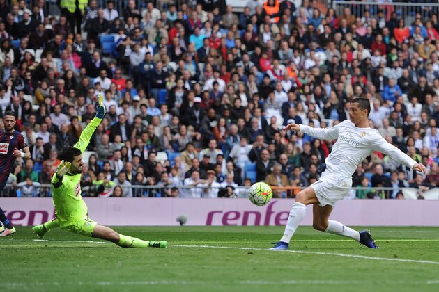MADRID, SPAIN - APRIL 09:  Cristiano Ronaldo of Real Madrid shoots past Asier Riesgo to score his side's 2nd goal during the La Liga match between Real Madrid and Eibar at Estadio Santiago Bernabeu on April 9, 2016 in Madrid, Spain.  (Photo by Denis Doyle/Getty Images)