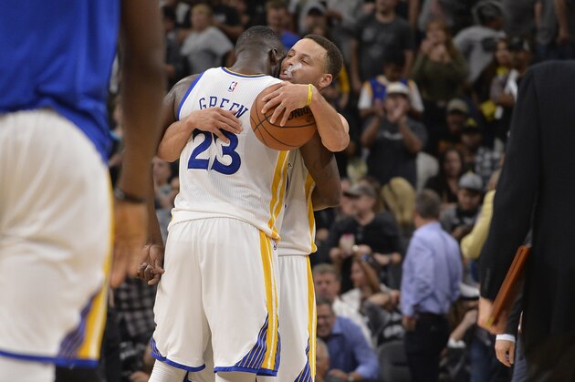 Golden State Warriors' Stephen Curry, right, and Draymond Green, celebrate the win after an NBA basketball game against the San Antonio Spurs, Sunday, April 10, 2016, in San Antonio. Golden State won 92-86. (AP Photo/Darren Abate)