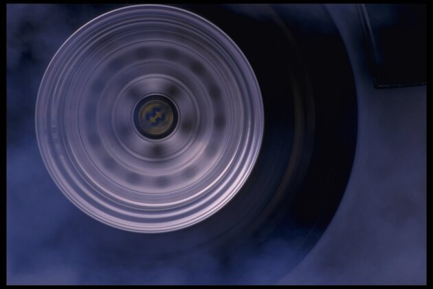 Portrait of a drag car's wheel as it starts its turning at the National Hot Rod Association Winternationals at Pomona Dragway in Pomona, California.