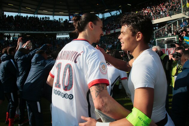 Paris Saint-Germain's Brazilian defender Thiago Silva (R) celebrates with Swedish forward Zlatan Ibrahimovic after winning the French Ligue 1 football match against Troyes to clinch a fourth consecutive Ligue 1 crown on March 13, 2016 at the Aube Stadium in Troyes.
Paris Saint-Germain clinched a fourth consecutive Ligue 1 title in record time on March 13 after defeating Troyes, obliterating a new French record for the quickest league victory with eight games to spare before the end of the L1 championships. / AFP / JACQUES DEMARTHON        (Photo credit should read JACQUES DEMARTHON/AFP/Getty Images)