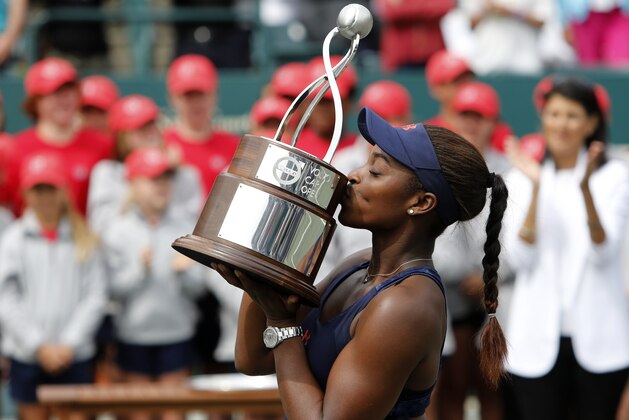 Sloane Stephens kisses the trophy after defeating Elena Vesnina, of Russia, during their finals tennis match at the Volvo Car Open in Charleston, S.C., Sunday, April 10, 2016. Stephens won 7-6 (4), 6-2. (AP Photo/Mic Smith)