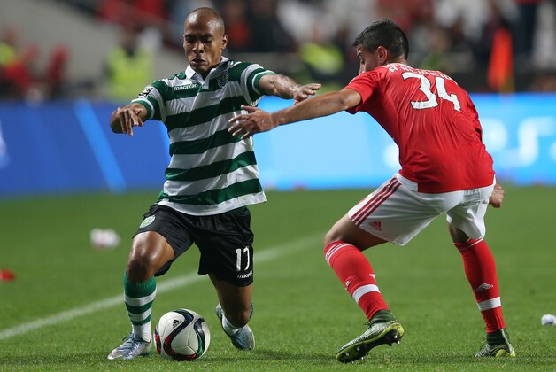 Sporting’s Joao Mario, left, tries to get past Benfica’s Andre Almeida during a Portuguese league soccer match at Benfica's Luz stadium in Lisbon, Sunday, Oct. 25, 2015. (AP Photo/Steven Governo)