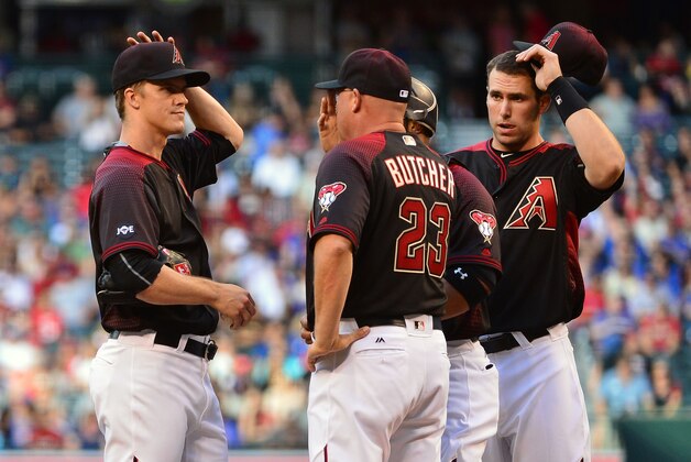 Apr 9, 2016; Phoenix, AZ, USA; Arizona Diamondbacks pitching coach Mike Butcher (23) talks with starting pitcher Zack Greinke (21) on the mound during the first inning of the game against the Chicago Cubs at Chase Field. Mandatory Credit: Jennifer Stewart-USA TODAY Sports