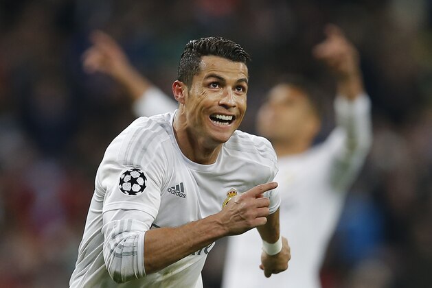 Real Madrid's Cristiano Ronaldo celebrates scoring his third goal during the Champions League 2nd leg quarterfinal soccer match between Real Madrid and VfL Wolfsburg at the Santiago Bernabeu stadium in Madrid, Spain, Tuesday April 12, 2016. (AP Photo/Paul White)