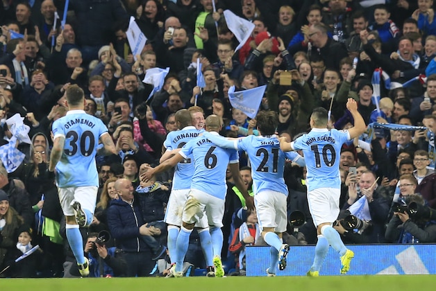Manchester City's Kevin De Bruyne, facing turns to his teammates as he celebrates scoring the opening goal of the game during the Champions League quarterfinal second leg soccer match between Manchester City and Paris Saint Germain at the City of Manchester stadium in Manchester, England  Tuesday, April 12, 2016. (AP Photo/ Jon Super)