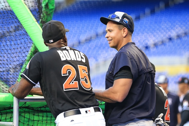 New York Yankees designated hitter Alex Rodriguez, right, talks with Miami Marlins hitting coach Barry Bonds (25) before an exhibition baseball game on Friday, April 1, 2016, in Miami. (AP Photo/Rob Foldy)
