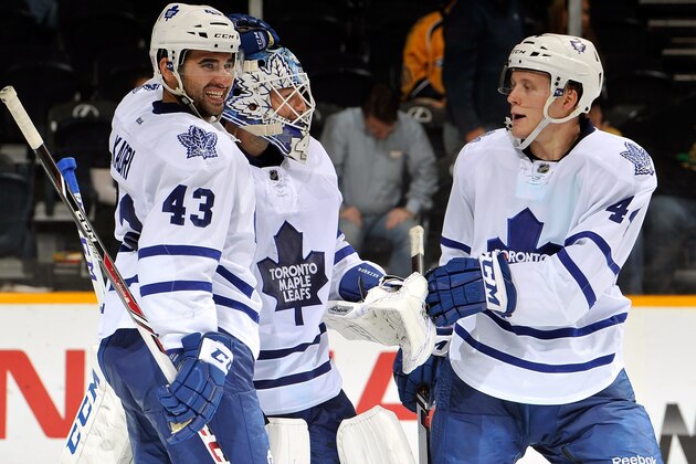 NASHVILLE, TN - OCTOBER 10:  Nazem Kadri #43 and Morgan Rielly #44 of the Toronto Maple Leafs congratulate teammate goalie Jonathan Bernier #45 after a victory over the Nashville Predators at Bridgestone Arena on October 10, 2013 in Nashville, Tennessee.  (Photo by Frederick Breedon/Getty Images)