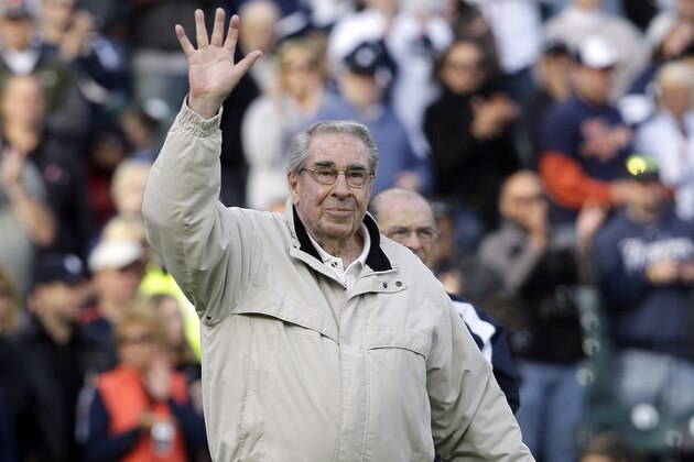 FILE - In this May 10, 2010, file photo, former Detroit Tigers broadcaster Paul Carey waves before throwing out a ceremonial pitch prior to the New York Yankees-Detroit Tigers baseball game in Detroit. Carey died Tuesday, April 12, 2016. He was 88. (AP Photo/Paul Sancya, File)