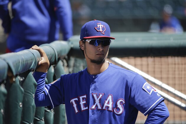 Texas Rangers' Yu Darvish, of Japan, watches from the dugout during a spring training baseball game against the Kansas City Royals Wednesday, March 30, 2016, in Surprise, Ariz. (AP Photo/Jae C. Hong)