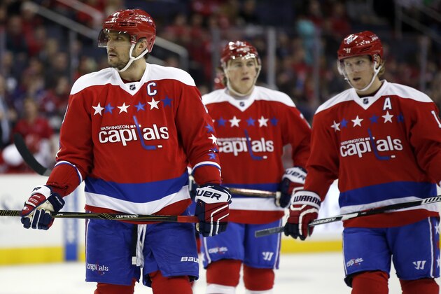 Washington Capitals left wing Alex Ovechkin, left, from Russia, Washington Capitals right wing T.J. Oshie (77), and Washington Capitals center Nicklas Backstrom (19), from Sweden, pause during a break in the first period of an NHL hockey game against the Pittsburgh Penguins, Thursday, April 7, 2016, in Washington. (AP Photo/Alex Brandon)