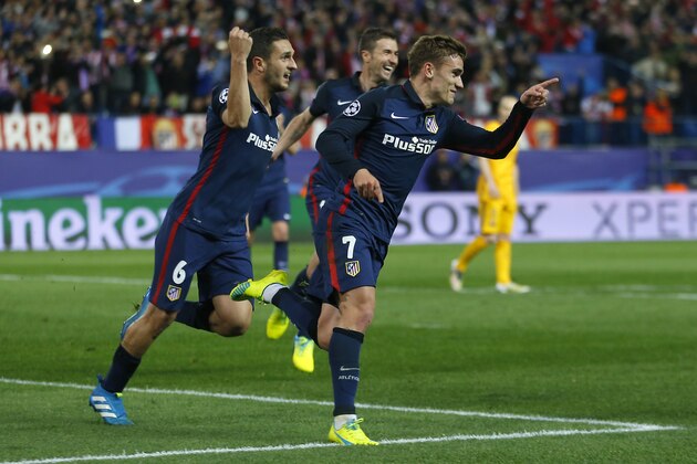 Atletico players celebrate with Antoine Griezmann, pointing right, after he scored his second goal during the Champions League 2nd leg quarterfinal soccer match between Atletico Madrid and Barcelona at the Vicente Calderon stadium in Madrid, Spain, Wednesday April 13, 2016. (AP Photo/Francisco Seco)