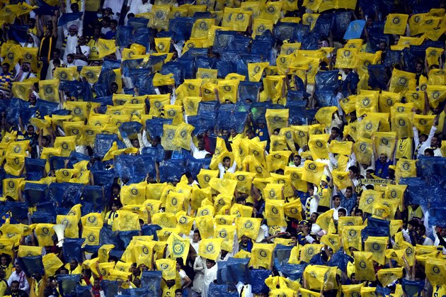 Saudi's Al-Nassr team fans celebrate after their team won their AFC Champions League group A football match against Iran's Persepolis team at the King Fahad stadium in Riyadh, on March 17, 2015. Al-Nassr won the match 3-0. AFP PHOTO / FAYEZ NURELDINE        (Photo credit should read FAYEZ NURELDINE/AFP/Getty Images)