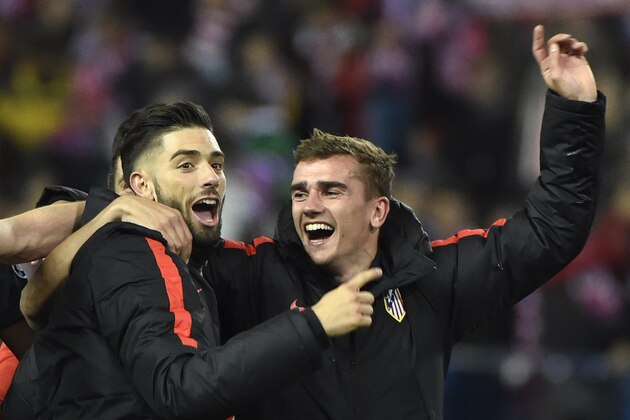 Atletico Madrid's Belgian midfielder Yannick Ferreira Carrasco and Atletico Madrid's French forward Antoine Griezmann (R) celebrate their win after the Champions League quarter-final second leg football match Club Atletico de Madrid VS FC Barcelona at the Vicente Calderon stadium in Madrid on April 13, 2016. / AFP / GERARD JULIEN        (Photo credit should read GERARD JULIEN/AFP/Getty Images)