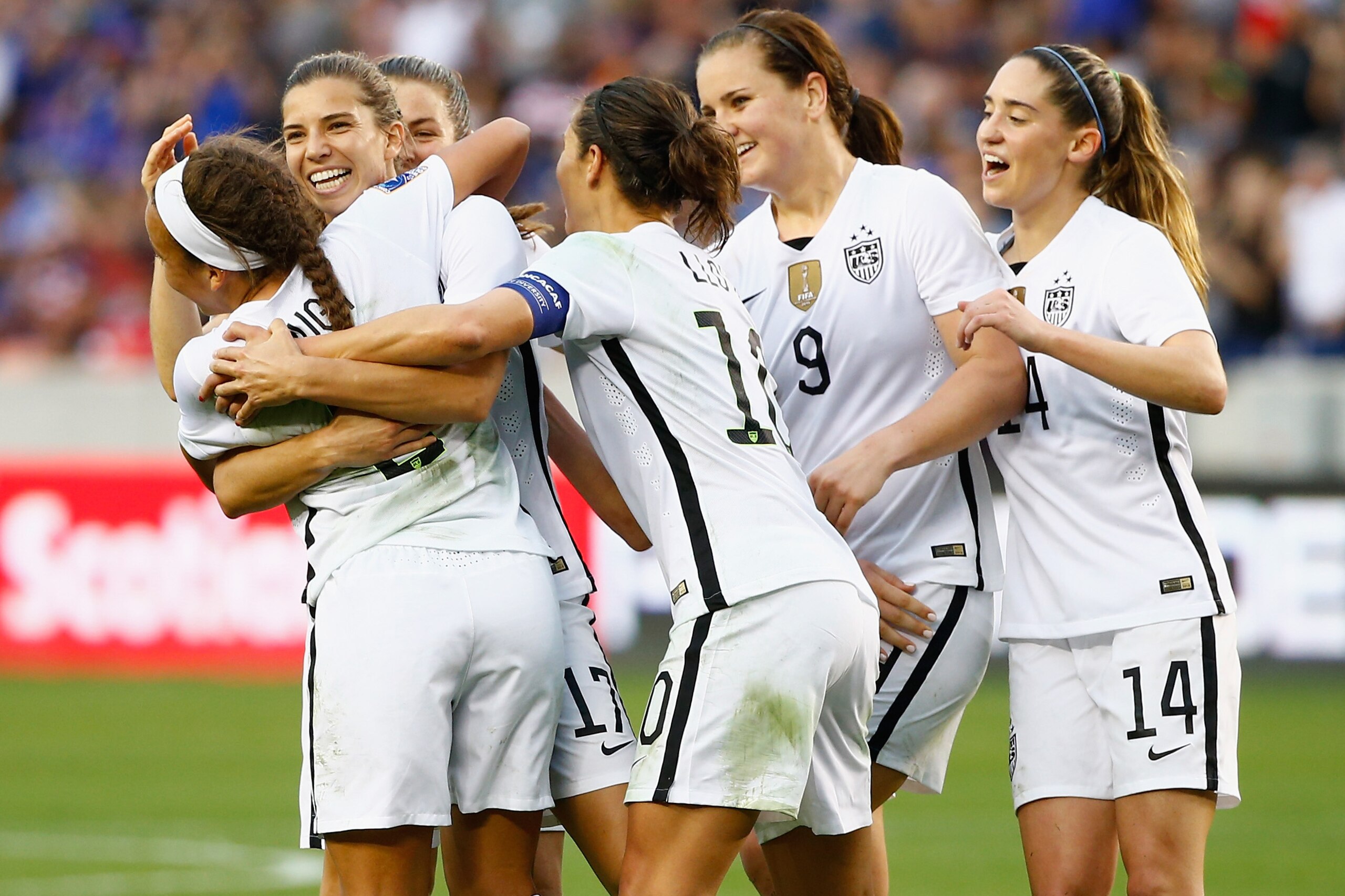 HOUSTON, TX - FEBRUARY 21:  Tobin Heath #17 of the United States gets mobbed by her teammates after Heath scored a second half goal against Canada during the Championship final of the 2016 CONCACAF Women's Olympic Qualifying at BBVA Compass Stadium on February 21, 2016 in Houston, Texas.  (Photo by Scott Halleran/Getty Images)