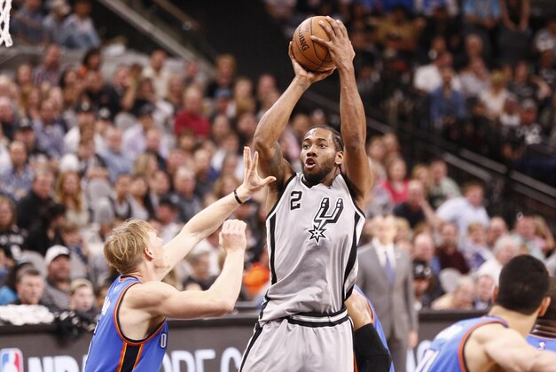 Mar 12, 2016; San Antonio, TX, USA; San Antonio Spurs small forward Kawhi Leonard (2) shoots the ball over Oklahoma City Thunder small forward Kyle Singler (5, front) during the first half at AT&T Center. Mandatory Credit: Soobum Im-USA TODAY Sports