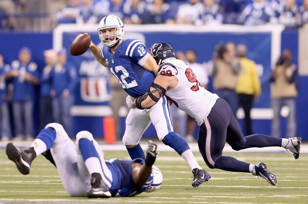 INDIANAPOLIS, IN - DECEMBER 14:  Andrew Luck #12 of the Indianapolis Colts is sacked by J.J. Watt #99 of the Houston Texans during the game at Lucas Oil Stadium on December 14, 2014 in Indianapolis, Indiana.  The Colts won 17-10.  (Photo by Andy Lyons/Getty Images)