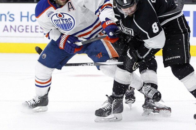 Edmonton Oilers left wing Taylor Hall (4) battles Los Angeles Kings defenseman Drew Doughty (8) for the puck with center Trevor Lewis (22) looking on during the third period of an NHL hockey game in Los Angeles, Saturday, March 26, 2016. The Kings won 6-4. (AP Photo/Alex Gallardo)