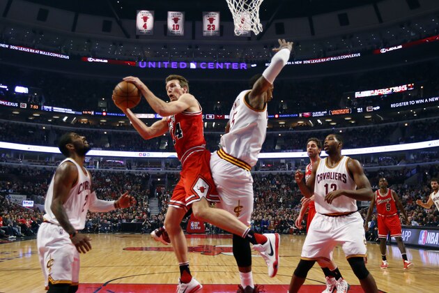 Chicago Bulls guard Mike Dunleavy (34) grabs a rebound from Cleveland Cavaliers guard J.R. Smith (5) during the first half of an NBA basketball game in Chicago, on Friday, April 9, 2016.  (AP Photo/Jeff Haynes)