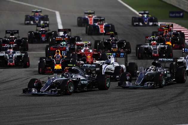 SAKHIR, BAHRAIN - APRIL 03: Nico Rosberg of Germany driving the (6) Mercedes AMG Petronas F1 Team Mercedes F1 WO7 Mercedes PU106C Hybrid turbo leads teammate Lewis Hamilton of Great Britain driving the (44) Mercedes AMG Petronas F1 Team Mercedes F1 WO7 Mercedes PU106C Hybrid turbo and the rest of the field into the first corner during the Bahrain Formula One Grand Prix at Bahrain International Circuit on April 3, 2016 in Sakhir, Bahrain.  (Photo by Mark Thompson/Getty Images)