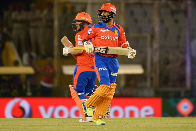 Gujarat Lions Dinesh Karthik (front) runs between the wickets along with Aaron Finch during the 2016 Indian Premier League (IPL) Twenty20 cricket match between Gujarat Lions and Kings XI Punjab at The Punjab Cricket Association Stadium in Mohali on April 11, 2016. ------IMAGE RESTRICTED TO EDITORIAL USE - STRICTLY NO COMMERCIAL USE- / AFP / SAJJAD HUSSAIN        (Photo credit should read SAJJAD HUSSAIN/AFP/Getty Images)